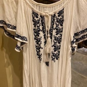 White top with navy design. Has a tie frayed ends